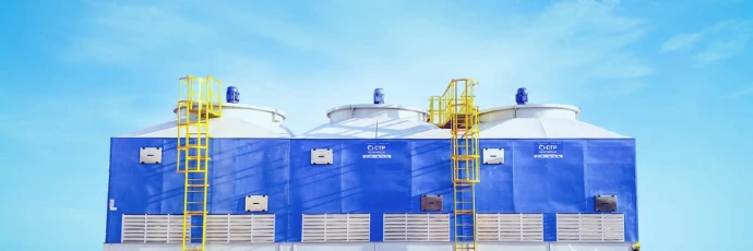 blue and white storage tanks under clear sky
